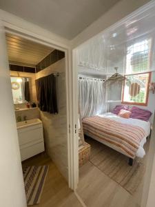 a small bedroom with a bed and a bathroom at Maison de vacance bord de mer in Le Barcarès