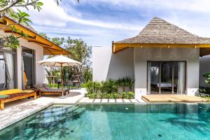 a villa with a swimming pool and a house at Anchan Flora by Villacarte in Ban Phru Champa +58 photos