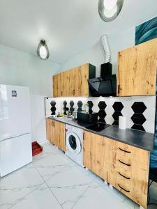 a kitchen with a washing machine and a washer at Квартира у Моря in Batumi