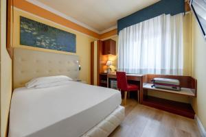 Ένα ή περισσότερα κρεβάτια σε δωμάτιο στο iH Hotels Padova Admiral