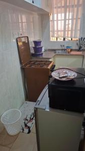 a kitchen with a stove and a counter top at Ponton Stays in Eldoret +2 photos