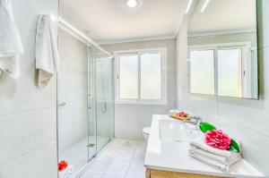 a white bathroom with a shower and a sink at Ideal Property Mallorca - Tacaritx in Cielo de Bonaire  +50 photos