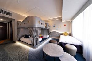 a hotel room with a bed and a table at Hotel Keihan Universal Tower in Osaka