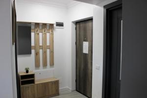 a hallway with a door and baseball bats on the wall at Cozy Apartments in Centre of Suceava near Kaufland and University in Suceava