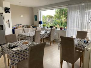 a dining room with a table and chairs and a window at Hillcrest Bed & Breakfast in Eyemouth
