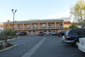 a parking lot in front of a building at El Rancho Inn in Hawthorne