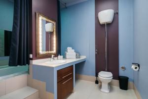 a bathroom with a sink and a toilet at Native Apartments Krupnicza 7 in Kraków +37 photos