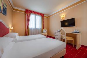 Ένα ή περισσότερα κρεβάτια σε δωμάτιο στο iH Hotels Padova Admiral