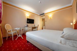 Ένα ή περισσότερα κρεβάτια σε δωμάτιο στο iH Hotels Padova Admiral