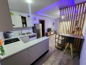 a kitchen with white cabinets and a counter top at la rivière in Nabeul +4 photos