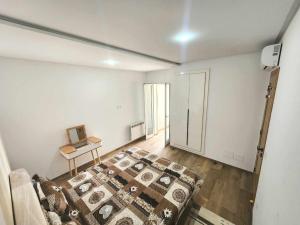 a bedroom with a bed and a table in it at la rivière in Nabeul
