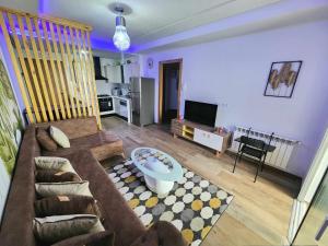 a living room with a couch and a table at la rivière in Nabeul