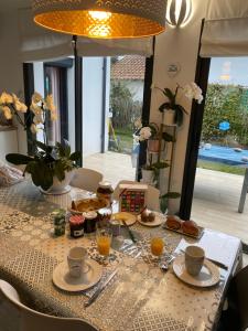 a table with food and drinks on top of it at Chambre d'hôtes près de la plage in Pornichet +11 photos