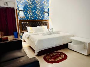 a bedroom with a bed and a couch at Hotel Green Land in Bāndarban