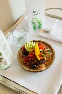 a plate of food on a table with fruit on it at Hospes Amérigo, Alicante, a Member of Design Hotels in Alicante