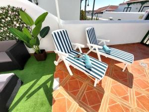 two blue and white chairs on a balcony at Mucha Vida in Abades