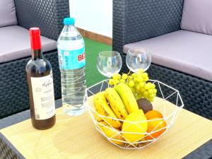 a basket of fruit and a bottle of wine on a table at Mucha Vida in Abades