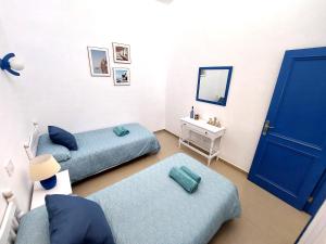 a room with two beds and a blue door at Mucha Vida in Abades +27 photos
