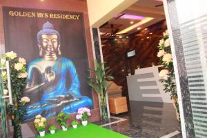 a large painting of a buddha in a lobby at Golden IB'S Gokarna in Gokarna