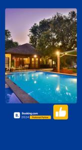 a picture of a swimming pool in front of a house at EKO STAY- BALI VILLA in Alibaug