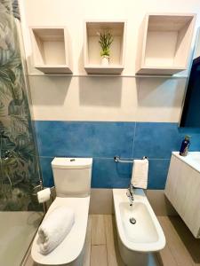a bathroom with a toilet and a sink at La Pavoncella Holiday Home in San Vito +92 photos