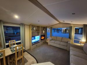 a living room with a couch and a table at Sapphire in Saint Leonards