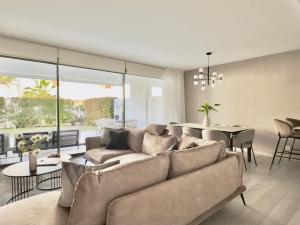 a living room with a couch and a dining room at Casa Elegante Casares Costa Golf in Casares