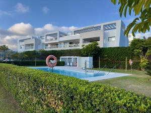 a house with a swimming pool in front of it at Casa Elegante Casares Costa Golf in Casares