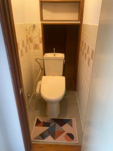 a bathroom with a toilet and a mosaic floor at 静佳民宿 in Osaka