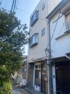 an apartment building in the middle of a street at 静佳民宿 in Osaka