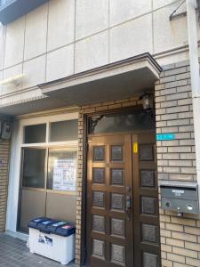 an entrance to a building with a wooden door at 静佳民宿 in Osaka