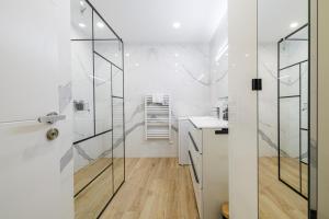 a bathroom with a glass shower and a sink at Le Mediterranée-centre-climatisation in Menton +21 photos