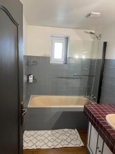 a bathroom with a bath tub and a sink at Country home in Saint-Ciers-sur-Bonnieure +28 photos