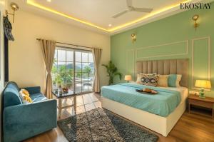 a bedroom with a blue bed and a blue chair at EKOSTAY - Ezra Villa in Anjuna +23 photos