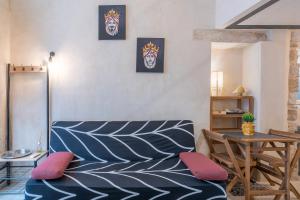 a living room with a couch and a table at Gargallo Loft in Ortigia in Siracusa +12 photos