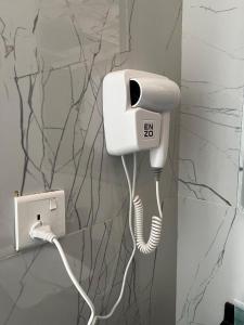 a phone with a cord plugged into a wall at Wadi rum Ali camp in Wadi Rum