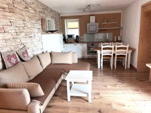 a living room and kitchen with a couch and a table at Ana's Landhaus auch für Monteure in Heretsried