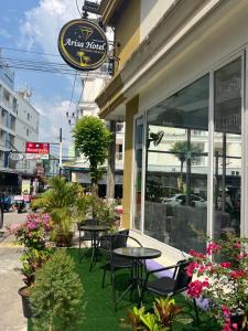 a restaurant with tables and chairs in front of a building at Arisa Hotel Patong Beach in Patong Beach