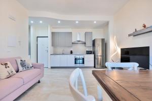 a living room with a couch and a table at GOLDEN LUXE - Sunny Apartment Near the Sea in Lido di Camaiore