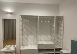 a white closet with shelves and lights in a room at Casa Quetta in Bari +18 photos