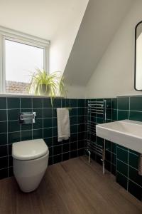 a bathroom with a toilet and a sink at Ledgers Cottage- Harbourfront Home Pittenweem in Pittenweem +23 photos