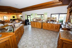 a large kitchen with wooden cabinets and counter tops at Hotel Traube Lossburg in Loßburg