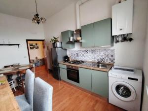 a kitchen with a sink and a washing machine at Debby Appartamenti in Montepulciano