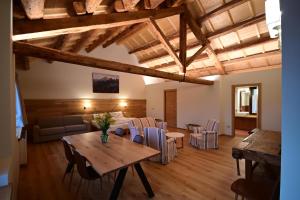a living room with a table and a couch at Agriturismo Villa di Modolo - Cortile della Latteria in Belluno