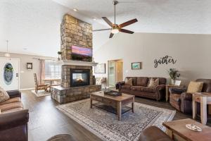 a living room with a couch and a fireplace at A Dolly Good Time in Sevierville +26 photos