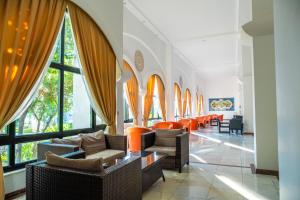 a waiting room with orange chairs and windows at Sural Hotel in Side