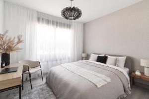 a bedroom with a bed and a desk and a window at Casa Elegante Casares Costa Golf in Casares +84 photos