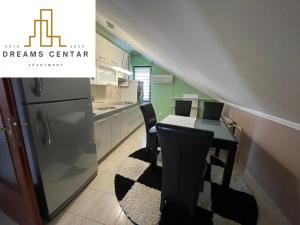 a kitchen with a table and chairs and a staircase at Apartments Dreams Centar in Živinice