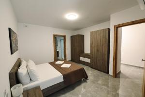 a bedroom with a bed with two towels on it at Cerviola Luxury 3 bedroom Apartments in Il-Ħamrija