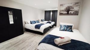a room with two beds and a couch in it at Dinas Accommodation Flat 3 in Oranjemund